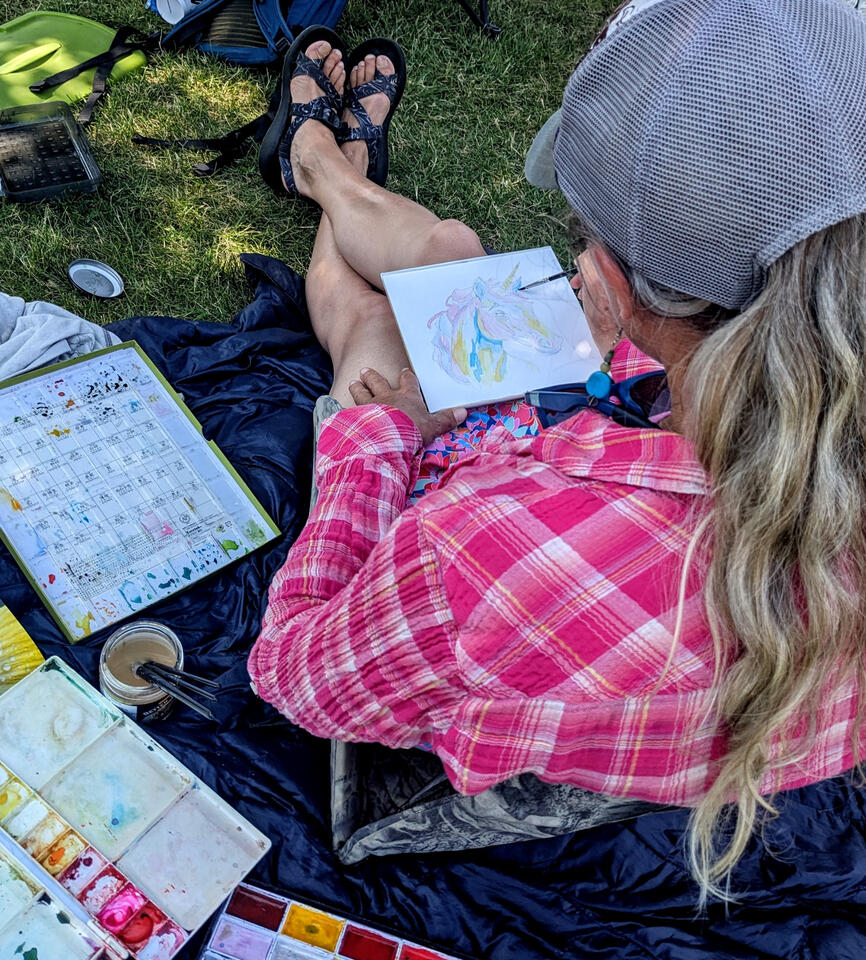 Heather using watercolros to paint a Unicorn